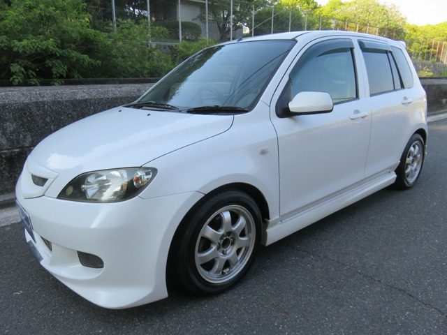 デミオ(マツダ) 1.3 カジュアル　フレンドパッケージAオートエグゼエアロ 中古車画像